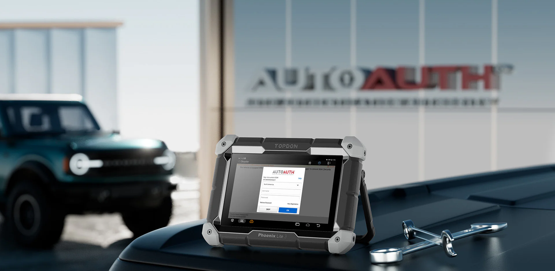 Topdon Phoenix Lite 3 diagnostic tablet displaying AutoAuth login screen on a vehicle with wrenches.